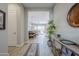 Bright and inviting hallway with elegant decor, leading to an open-concept living and dining area with natural light at 20373 W Coolidge St, Buckeye, AZ 85396