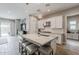 Open kitchen featuring a large island with seating, white cabinets, and modern pendant lighting at 20373 W Coolidge St, Buckeye, AZ 85396