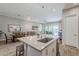 Kitchen with dining area, stainless steel sink, bar stools and view to the living area and backyard at 20373 W Coolidge St, Buckeye, AZ 85396