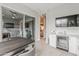 Bright eat-in kitchen boasts modern finishes, an island, and a beverage fridge next to a sliding glass door at 20373 W Coolidge St, Buckeye, AZ 85396