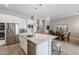 Kitchen with white cabinetry, stainless steel appliances, a center island and an eat-in breakfast area at 20373 W Coolidge St, Buckeye, AZ 85396