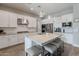 Modern kitchen featuring white cabinets, stainless appliances, and a center island with barstool seating at 20373 W Coolidge St, Buckeye, AZ 85396
