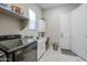 Bright laundry area with a convenient workspace, storage cabinets and modern appliances at 20373 W Coolidge St, Buckeye, AZ 85396
