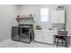 Well-lit laundry room featuring modern washer and dryer, countertop and storage space at 20373 W Coolidge St, Buckeye, AZ 85396