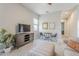 The living room offers a neutral color palette, a ceiling fan, and comfortable seating at 20373 W Coolidge St, Buckeye, AZ 85396