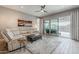 Comfortable living room with tile flooring, a reclining sofa set and a large sliding glass doors to the backyard at 20373 W Coolidge St, Buckeye, AZ 85396