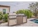 Well-equipped outdoor kitchen featuring a grill, stainless steel appliances, and ample counter space for food preparation and dining at 20373 W Coolidge St, Buckeye, AZ 85396