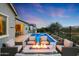 Inviting backyard oasis featuring a sparkling pool, spa, fire pit, and comfortable seating area, perfect for outdoor entertaining at 20373 W Coolidge St, Buckeye, AZ 85396