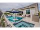 Inviting pool with a spa, stylish patio furniture, and a built-in outdoor grill, perfect for entertaining and relaxation at 20373 W Coolidge St, Buckeye, AZ 85396