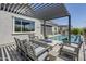Outdoor seating area with fire pit overlooks swimming pool and outdoor kitchen at 20373 W Coolidge St, Buckeye, AZ 85396