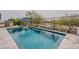 Backyard pool with an umbrella stand and outdoor grill; ideal for summer relaxation at 20373 W Coolidge St, Buckeye, AZ 85396