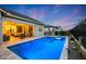 Captivating backyard featuring a sparkling pool, covered patio, and outdoor cooking area for luxurious outdoor living at 20373 W Coolidge St, Buckeye, AZ 85396