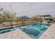 Sparkling backyard pool featuring a built-in umbrella stand and adjacent hot tub for relaxation at 20373 W Coolidge St, Buckeye, AZ 85396