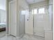 This primary bath features a large glass enclosed shower and marble floors at 20373 W Coolidge St, Buckeye, AZ 85396