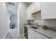 Stylish wet bar area featuring white cabinets, granite countertops, a sink, and a beverage fridge at 20373 W Coolidge St, Buckeye, AZ 85396