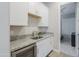 Convenient wet bar with granite counters, cabinets, a sink, and a beverage fridge near the bedroom at 20373 W Coolidge St, Buckeye, AZ 85396