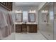 Primary bathroom featuring double sinks, vanity, shower, and modern lighting at 20445 W Rovey Ave, Buckeye, AZ 85396