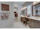 Bathroom featuring double sinks, vanity, shower, and a door to the walk in closet at 20445 W Rovey Ave, Buckeye, AZ 85396