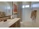 Bathroom featuring a vanity, shower with glass door, and modern fixtures at 20445 W Rovey Ave, Buckeye, AZ 85396
