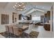Open-concept dining and kitchen area with modern chandelier and ample seating at 20445 W Rovey Ave, Buckeye, AZ 85396
