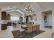 Open-concept dining and kitchen area with modern chandelier and ample seating at 20445 W Rovey Ave, Buckeye, AZ 85396