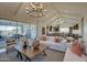 Bright living room featuring vaulted ceilings, modern decor, and an open layout at 20445 W Rovey Ave, Buckeye, AZ 85396