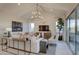 Bright living room with modern decor, vaulted ceilings, and large windows at 20445 W Rovey Ave, Buckeye, AZ 85396