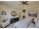 Bright main bedroom featuring decor, dresser with mirror, and cozy chair at 20445 W Rovey Ave, Buckeye, AZ 85396
