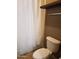 Bathroom showcasing toilet, shower curtain, shelf, and neutral tones at 22744 E Carla Vista Dr, Mesa, AZ 85212