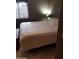 Bedroom showcases natural light through a window and a cozy quilt at 22744 E Carla Vista Dr, Mesa, AZ 85212