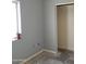 Bedroom features a large window offering natural light and a spacious closet for storage at 22744 E Carla Vista Dr, Mesa, AZ 85212