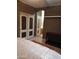 Bedroom featuring hardwood floors, closet with mirrored doors, and an adjacent arched doorway to bathroom at 22744 E Carla Vista Dr, Mesa, AZ 85212