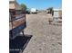Exterior of gravel parking lot and multiple vehicles including a utility trailer at 22744 E Carla Vista Dr, Mesa, AZ 85212