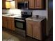 Galley-style kitchen with stainless steel appliances, granite countertops, and light wood cabinets at 22744 E Carla Vista Dr, Mesa, AZ 85212