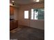 Bright kitchen features natural wood cabinets, granite counters, sink and a large window at 22744 E Carla Vista Dr, Mesa, AZ 85212