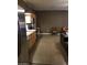 Open-concept living room with stainless steel appliances, bar top, and neutral color scheme at 22744 E Carla Vista Dr, Mesa, AZ 85212