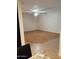 Large living room with new flooring, a ceiling fan, and a view into the kitchen at 22744 E Carla Vista Dr, Mesa, AZ 85212