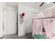 room with a whimsical canopy bed, neutral walls, and ceiling fan at 22787 W Gardenia Dr, Buckeye, AZ 85326