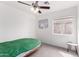 Simple bedroom with neutral paint, carpeted flooring, ceiling fan, and a window providing natural light at 22787 W Gardenia Dr, Buckeye, AZ 85326