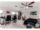 Spacious bedroom with two desks for work from home, ceiling fan and bed with a black cover at 22787 W Gardenia Dr, Buckeye, AZ 85326