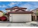 Charming two-story home featuring a red tile roof and spacious two-car garage at 22787 W Gardenia Dr, Buckeye, AZ 85326