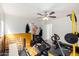 Home gym featuring exercise equipment, ceiling fan and a mounted punching dummy at 22787 W Gardenia Dr, Buckeye, AZ 85326