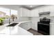Contemporary kitchen featuring white cabinetry, quartz countertops, stainless appliances, and a view to the outside at 22787 W Gardenia Dr, Buckeye, AZ 85326
