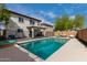 Beautiful backyard pool area with seating and mature tree at 22787 W Gardenia Dr, Buckeye, AZ 85326