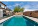 Backyard pool with lounge chairs, swing, and mature tree at 22787 W Gardenia Dr, Buckeye, AZ 85326