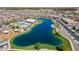 Breathtaking aerial view of a community lake, pool, clubhouse, and surrounding neighborhood at 23020 E Excelsior Ave, Queen Creek, AZ 85142