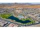Aerial view of the Primary-planned community with a lake, pool, playground, and mountain views at 23020 E Excelsior Ave, Queen Creek, AZ 85142