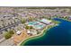 Aerial view showcases a community featuring a lake, swimming pool, playground, and recreational areas at 23020 E Excelsior Ave, Queen Creek, AZ 85142