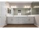 Primary bathroom featuring double sinks, vanity, and large mirrors at 23020 E Excelsior Ave, Queen Creek, AZ 85142