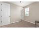 Neutral bedroom with carpet flooring, bright window and closet access at 23020 E Excelsior Ave, Queen Creek, AZ 85142